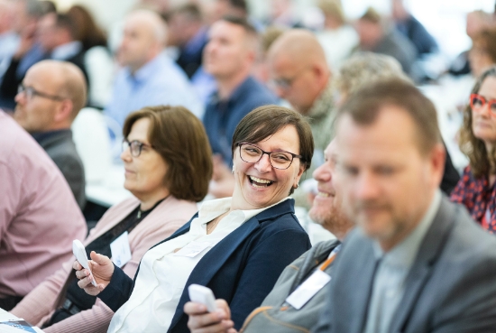 Woman laughing at conference